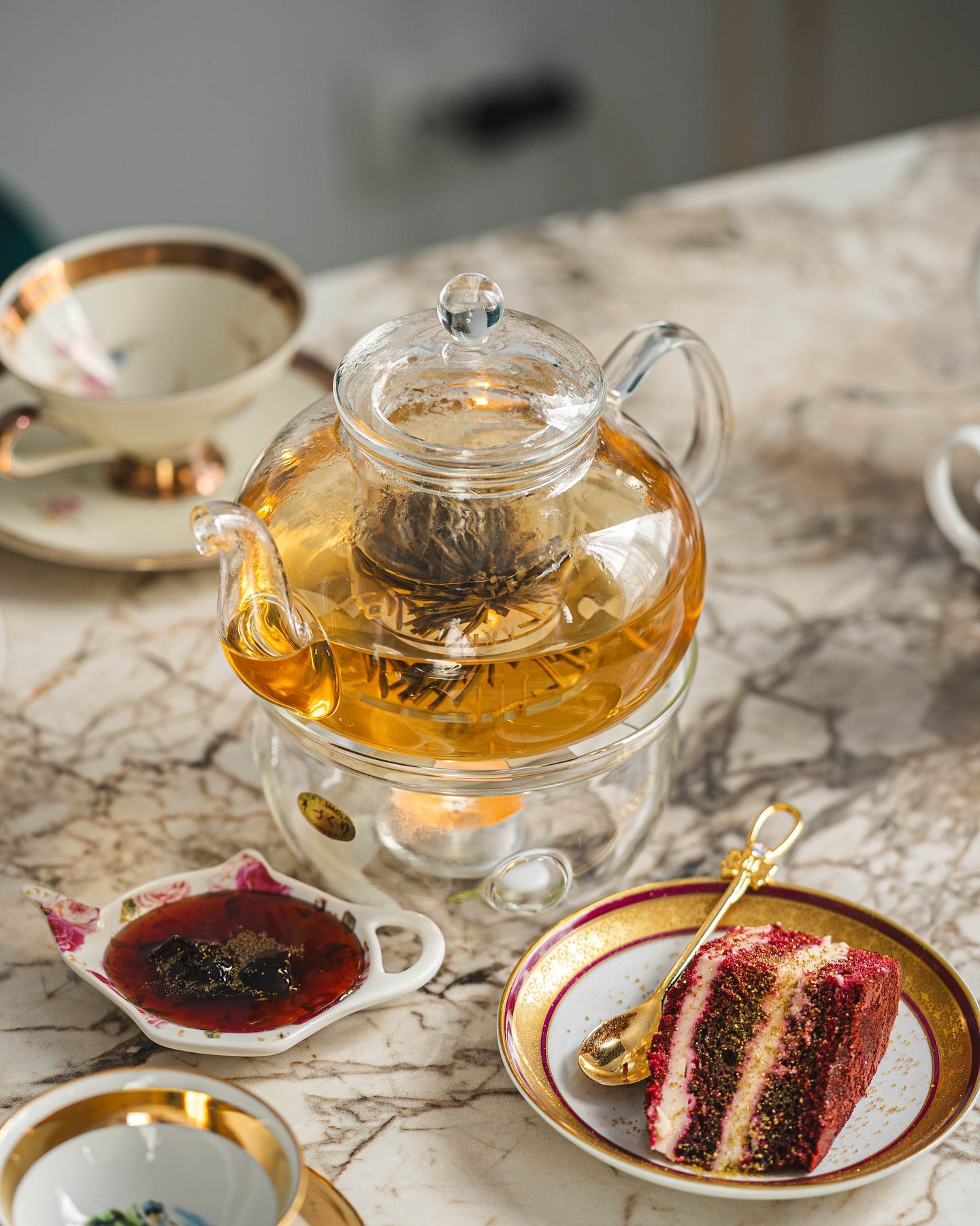 A table laid for High Tea with tea, sandwiches and desserts