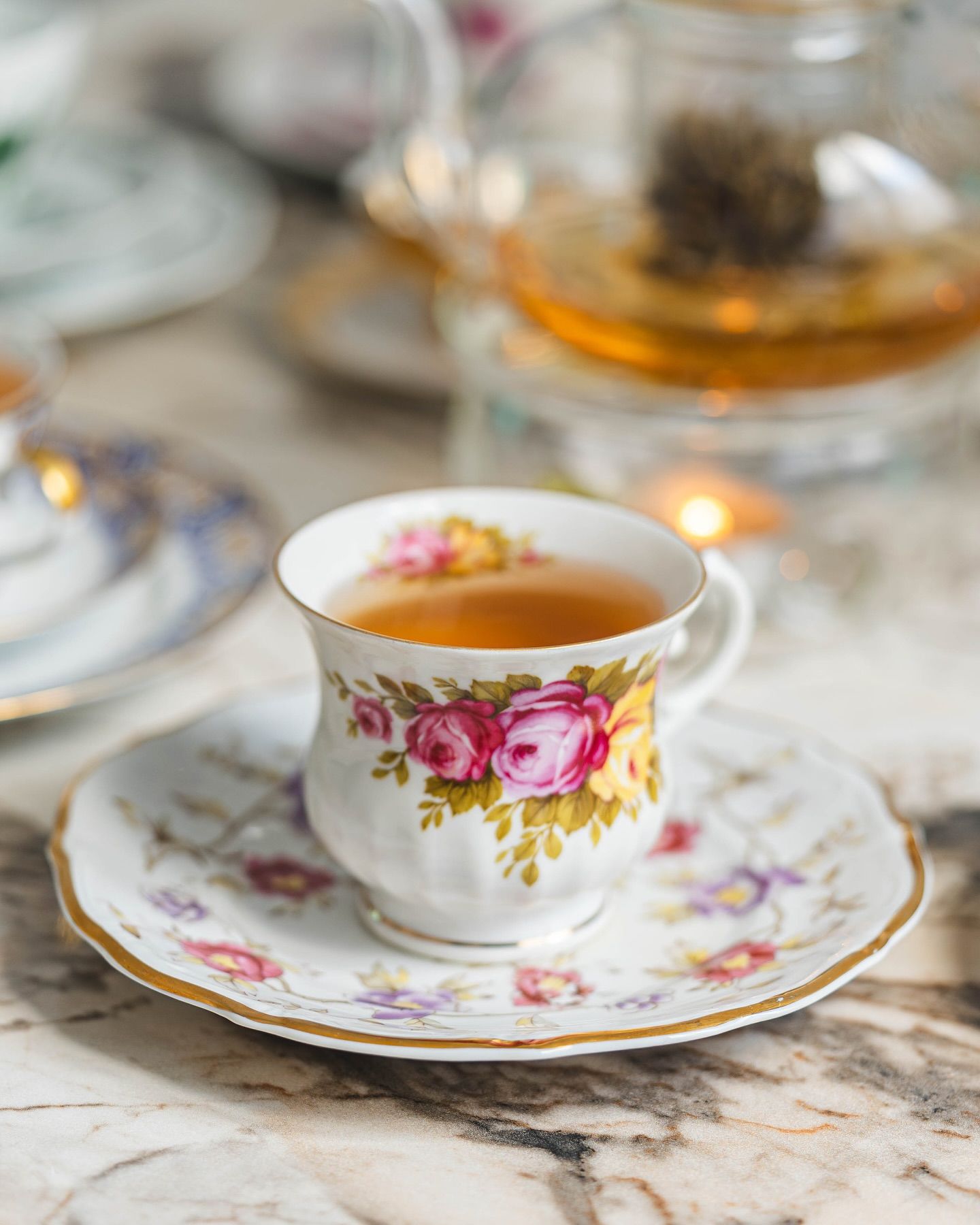 Tea poured from a glass teapot into a cup